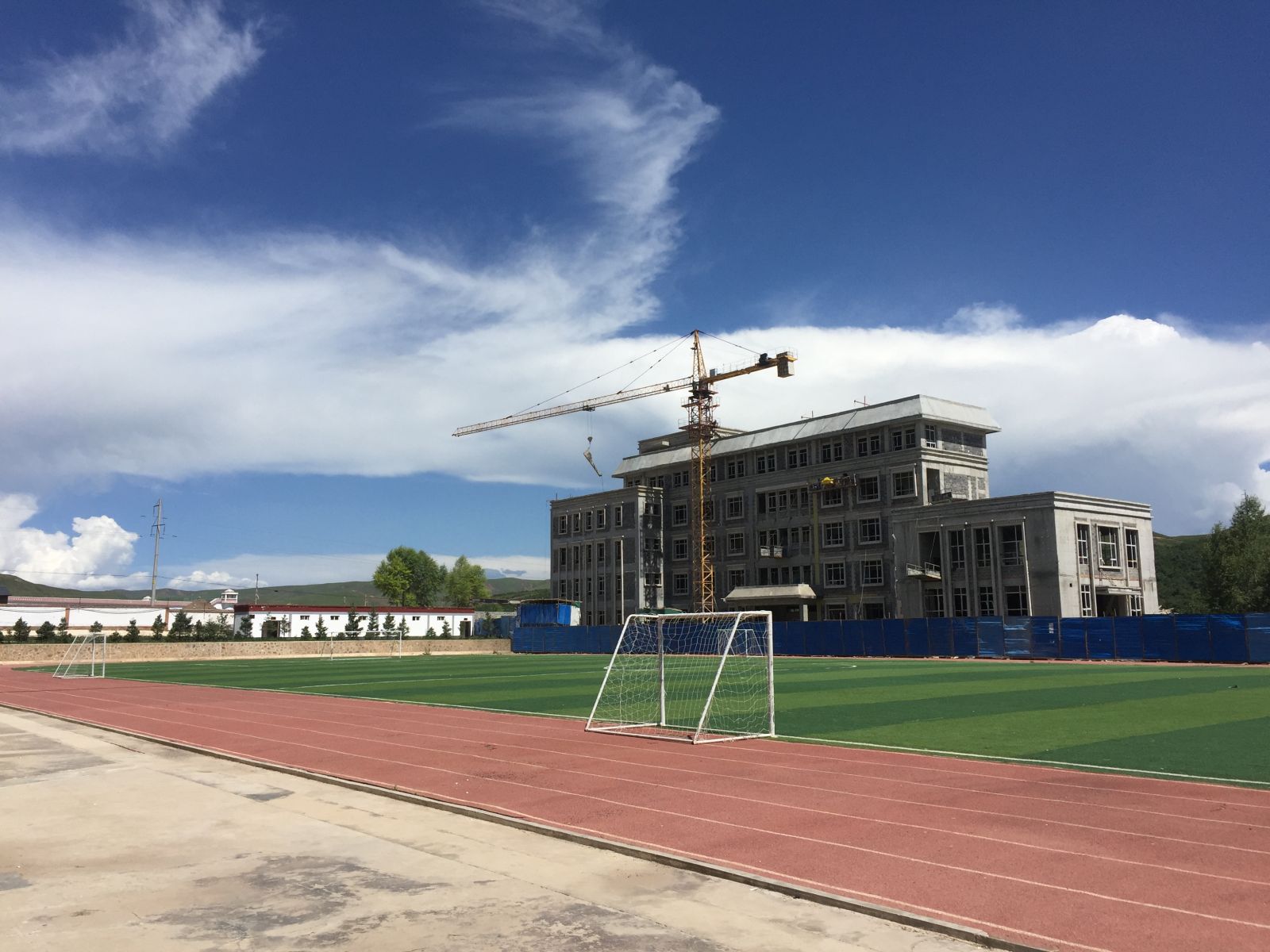 合作市四小操场和正在兴建的新教学楼